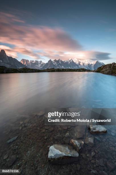 sunrise on mont blanc massif, france - lake chesery stockfoto's en -beelden