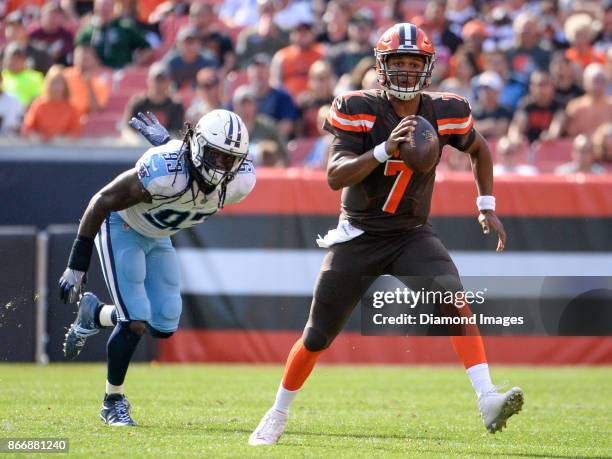 Quarterback DeShone Kizer of the Cleveland Browns carries the ball downfield as he is pursued by linebacker Erik Walden of the Tennessee Titans in...