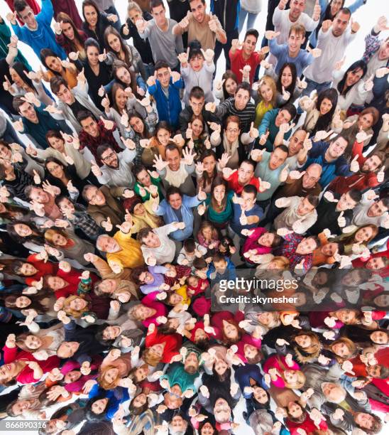 high angle view of crowd of people showing thumbs up. - crowd of people from above stock pictures, royalty-free photos & images