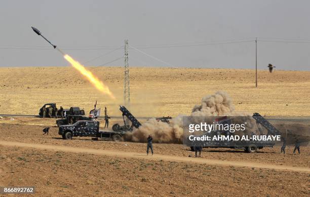 Picture taken on October 26, 2017 shows rockets being launched from Iraqi security forces' against Kurdish Peshmerga positions in the area of Faysh...