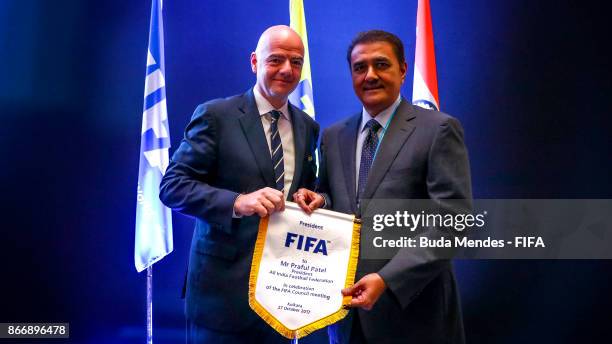 President Gianni Infantino hands over the FIFA penant to Praful Patel, President All India Football Federation during a FIFA Council Meeting at JW...