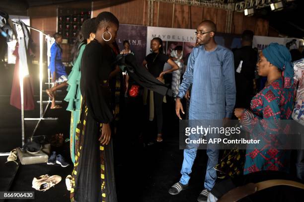 Designer Ibrahim Aminu speaks to models backstage before his "House of Kaya" fashion show during the Lagos Fashion and Design Week, on October 25,...