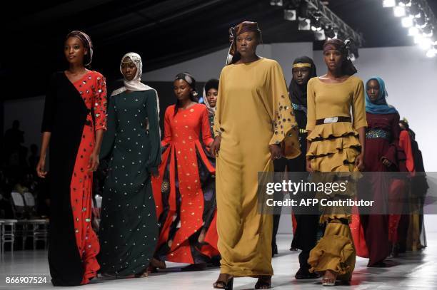 Models present creations by House of Kaya during the Lagos Fashion and Design Week, on October 25, 2017. Ibrahim Aminu's House of Kaya, so far is the...