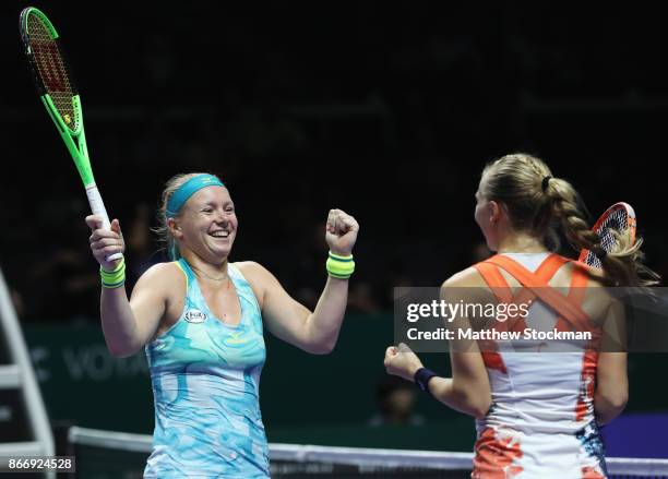 Kiki Bertens of Netherlands and Johanna Larsson of Sweden celebrate victory in their doubles match against Casey Dellacqua and Ashleigh Barty of...