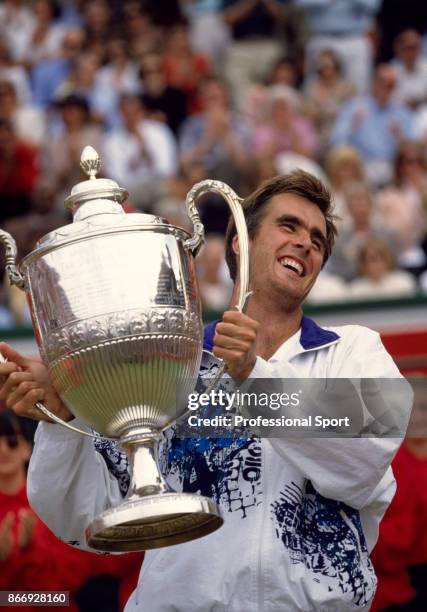 Todd Martin of the USA celebrates with the trophy after defeating Pete Sampras also of the USA in the singles Final of the Stella Artois...