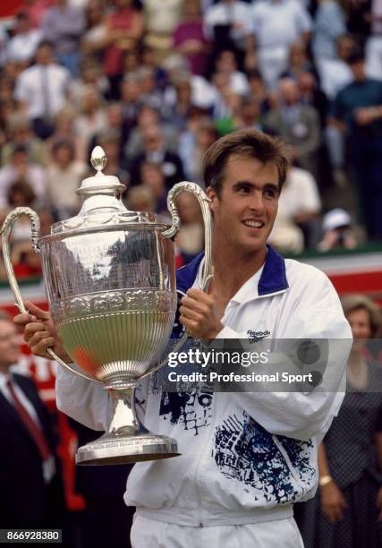 Todd Martin of the USA poses with the trophy after defeating Pete Sampras also of the USA in the singles Final of the Stella Artois Championships at...
