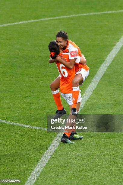 Allira Toby of the Roar celebrates with her team mate Hayley Raso of the Roar after scoring a goal during the round one W-League match between Sydney...