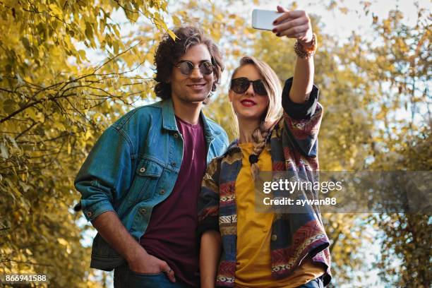 couple in park making selfie - park man made space stock pictures, royalty-free photos & images