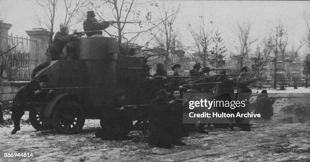 Red Guards firing from an armoured car during the Russian Revolution, Moscow, 1917. From The Russian Album.