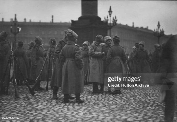 Group of soldiers from the Women's Battalion gathered in a square in Petrograd during the Russian Revolution, 1917. They are wearing overcoats and...