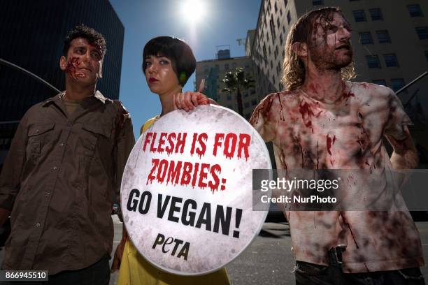 Animal rights activists dressed as zombies during a Halloween campaign against meat consumption in Los Angeles, California on October 26, 2017....