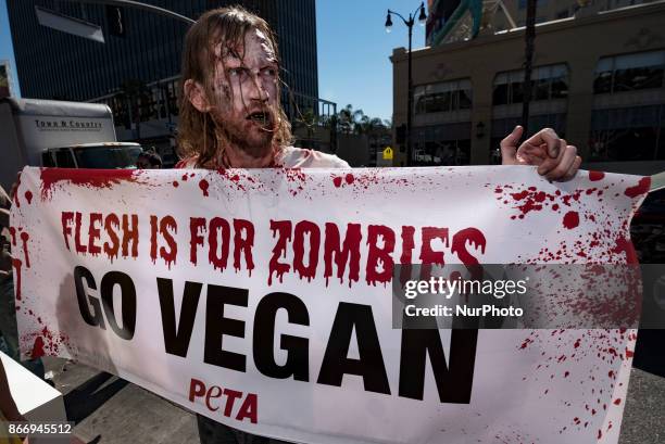 Animal rights activist dressed as a zombie during a Halloween campaign against meat consumption in Los Angeles, California on October 26, 2017....