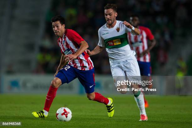 Nico Gaitan of Atletico de Madrid and Lolo Pla of Elche competes for the ball during the Spanish Copa del Rey round of 32 first league football match...