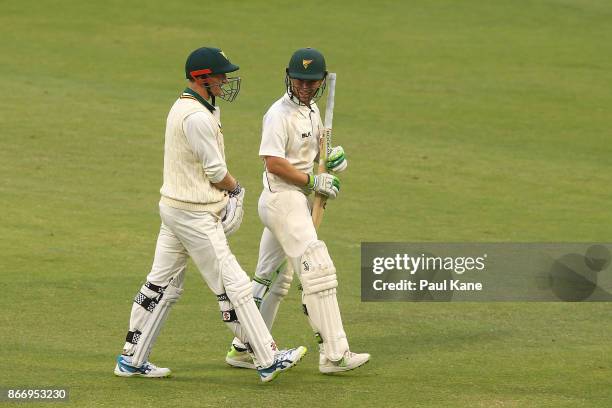 George Bailey and Jake Doran of the Tigers walk from the field after the umpires called for the covers due to light showers during day two of the...