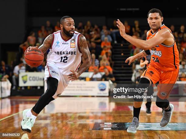 Shannon Shorter of the 36ers looks to get past Michael Carrera of the Taipans during the round four NBL match between the Cairns Taipans and the...