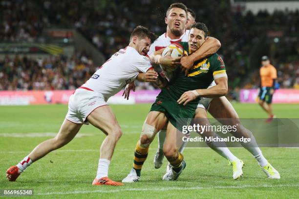 Billy Slater of the Kangaroos still scores a try after a heavy tackle from Sam Burgess of England during the 2017 Rugby League World Cup match...