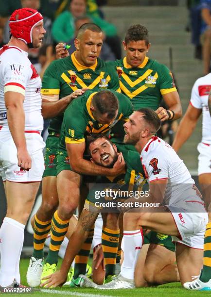 Matt Gillett of the Kangaroos is congratulated by Cameron Smith and his teammates after scoring a try during the 2017 Rugby League World Cup match...