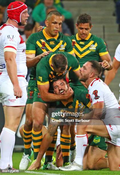 Matt Gillett of the Kangaroos is congratulated by Cameron Smith and his teammates after scoring a try during the 2017 Rugby League World Cup match...