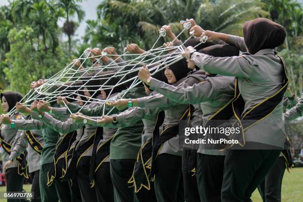 Indonesian women's police officers and women's soldiers took part on a perform traditional dance a Tarek Pukat at Alue Dua Village, North Aceh...
