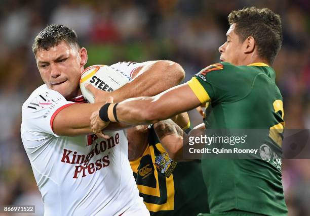 Ryan Hall of England fends off a tackle by Dane Gagai of Australia during the 2017 Rugby League World Cup match between the Australian Kangaroos and...