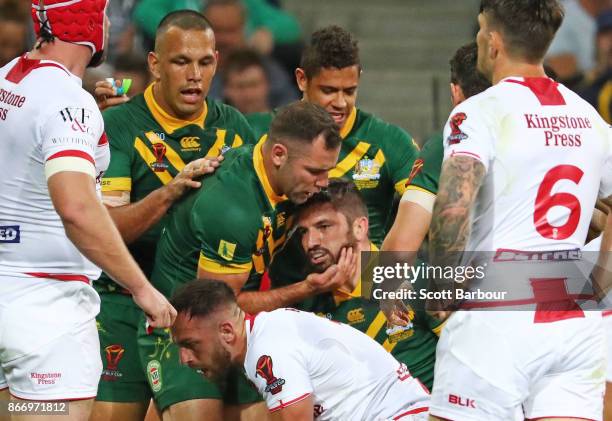 Matt Gillett of the Kangaroos is congratulated by Cameron Smith and his teammates after scoring a try during the 2017 Rugby League World Cup match...