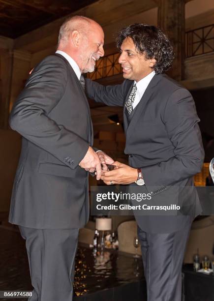 Film director M. Night Shyamalan presents actor Bruce Willis with the 2nd annual Lumiere award during the 2nd Annual Lumiere Award Celebration during...
