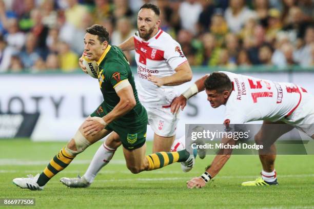 Billy Slater of the Kangaroos runs with the ball past Chris Heighington of England during the 2017 Rugby League World Cup match between the...