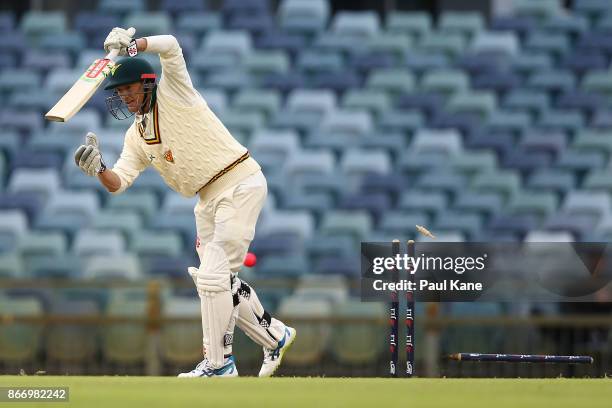 George Bailey of the Tigers is bowled by Jhye Richardson of Western Australia during day two of the Sheffield Shield match between Western Australia...