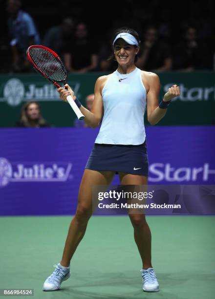 Caroline Garcia of France celebrates victory in her singles match against Caroline Wozniacki of Denmark during day 6 of the BNP Paribas WTA Finals...