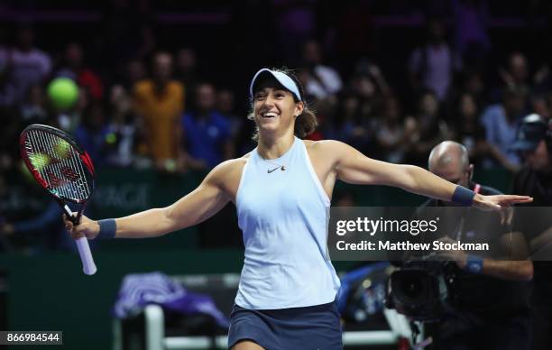 Caroline Garcia of France celebrates victory in her singles match against Caroline Wozniacki of Denmark during day 6 of the BNP Paribas WTA Finals...