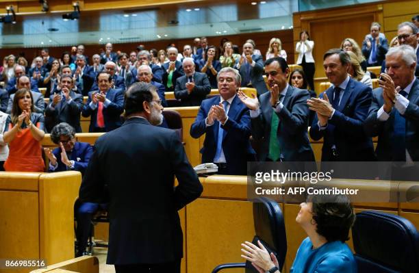 Spain's Prime Minister Mariano Rajoy acknowledges applause during a session of the Upper House of Parliament in Madrid on October 27, 2017. The...