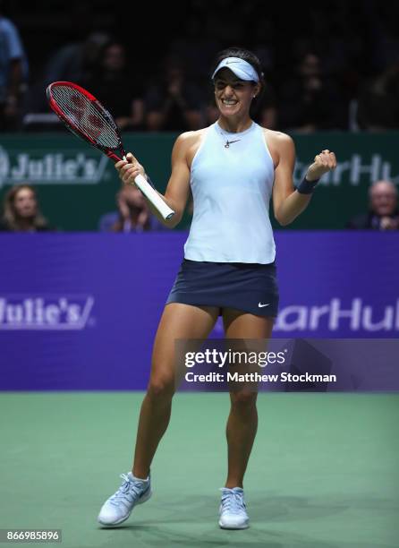 Caroline Garcia of France celebrates victory in her singles match against Caroline Wozniacki of Denmark during day 6 of the BNP Paribas WTA Finals...