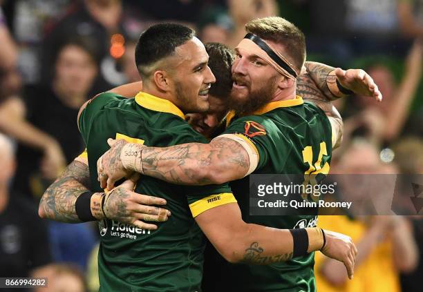 Joshua Dugan of Australia is congratulated by Valentine Holmes and Joshua McGuire after scoring a try during the 2017 Rugby League World Cup match...