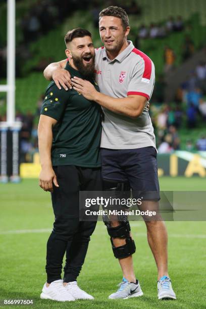 Josh Mansour of the Kangaroos consoles the defeated and injured Sam Burgess of England during the 2017 Rugby League World Cup match between the...