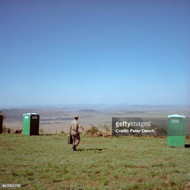 Soldier walks across the Spion Kop battlefield towards a temporary toilet.