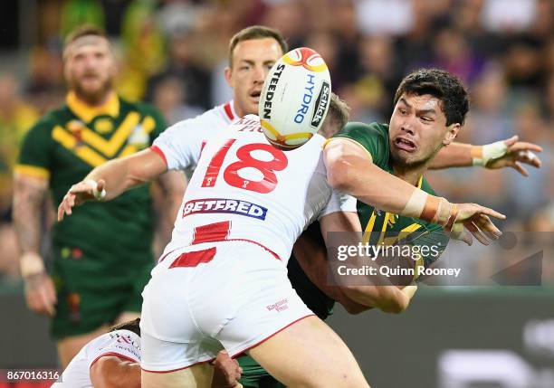 Jordan McLean of Australia passes the ball whilst being tackled during the 2017 Rugby League World Cup match between the Australian Kangaroos and...