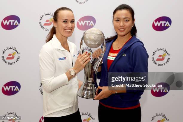 Martina Hingis of Switzerland and Chan Yung-Jan of Chinese Taipei pose with the WTA Year-End World No.1 Award presented by Dubai Duty Free during day...