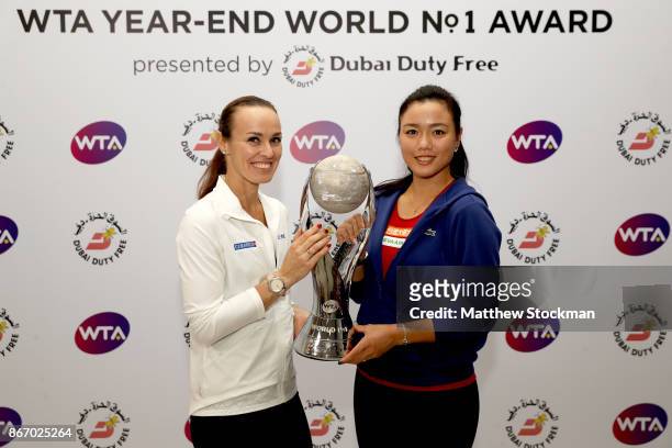 Martina Hingis of Switzerland and Chan Yung-Jan of Chinese Taipei pose with the WTA Year-End World No.1 Award presented by Dubai Duty Free during day...