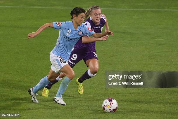 Yukari Kinga of Melbourne City runs with the ball under pressure from Rachel Hill of the Glory during the round one W-League match between the Perth...