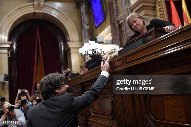 Catalan president Carles Puigdemont casts his vote for a motion on declaring independence from Spain, during a session of the Catalan parliament in...