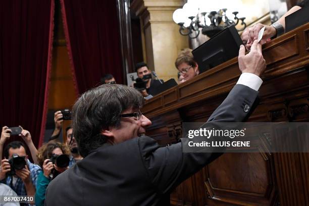 Catalan president Carles Puigdemont casts his vote for a motion on declaring independence from Spain, during a session of the Catalan parliament in...