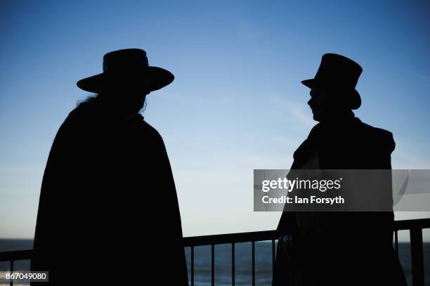 Two goths chat on the seafront during the Whitby Goth Weekend on October 27, 2017 in Whitby, England. The Whitby Goth Weekend began in 1994 and takes...