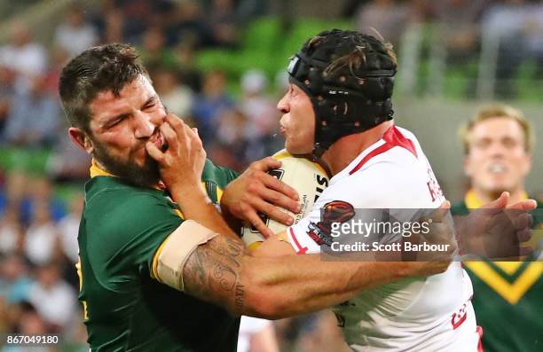 Jonny Lomax of England is tackled by Matt Gillett of the Kangaroos during the 2017 Rugby League World Cup match between the Australian Kangaroos and...