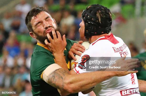 Jonny Lomax of England is tackled by Matt Gillett of the Kangaroos during the 2017 Rugby League World Cup match between the Australian Kangaroos and...