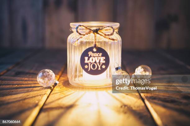 christmas decoration on old wood - candle jar label card - joy christmas stock pictures, royalty-free photos & images