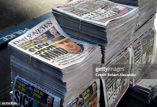 Stacks of Daily News and New York Post tabloid newspapers sit on a sidewalk in New York, New York. The headline refers to the results of a autopsy on...