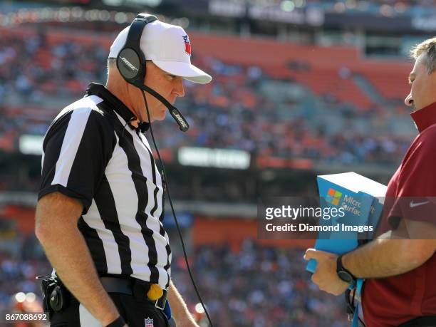 Referee Terry McAulay puts on his headset as he reviews a play in the second quarter of a game on October 22, 2017 between the Tennessee Titans and...