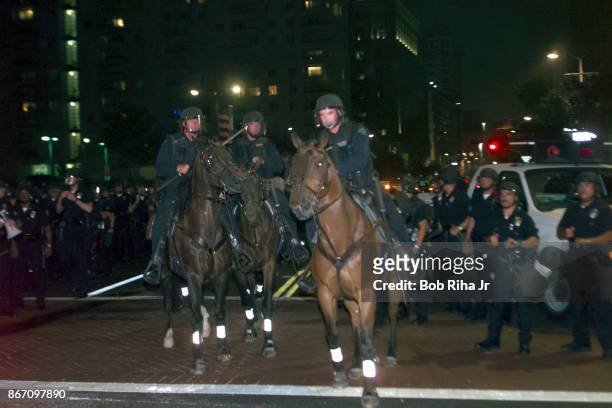 Los Angeles Police Department Horse mounted unit move forward to disperse demonstrators outside the Staples Center at the Democratic National...