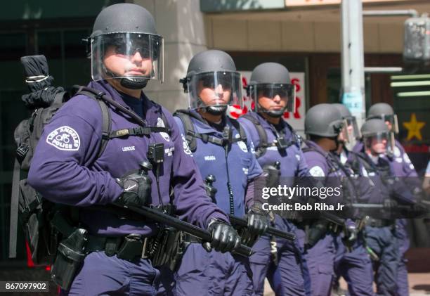 Los Angeles Police Department officers form a line blocking the route to the Staples Center - site of the Democratic National Convention, on August...