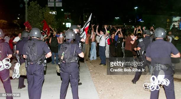 Los Angeles Police Department officers form a line blocking the route to the Staples Center - site of the Democratic National Convention, on August...